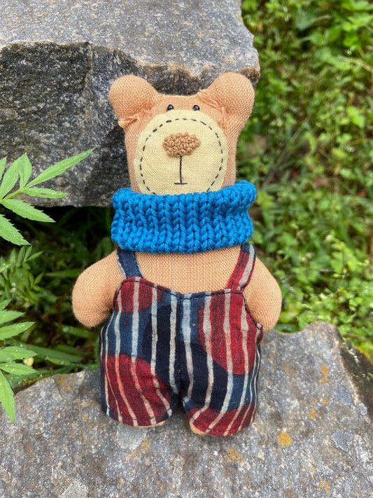 Stuffed bear in a jumpsuit